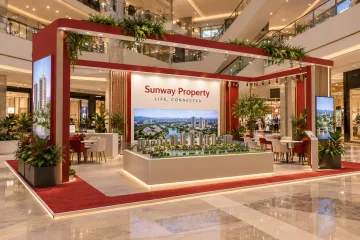 Sunway Property integrated living showcase with an open four-sided property roadshow island with overhead rectangular frame, township model, digital displays and consultation tables